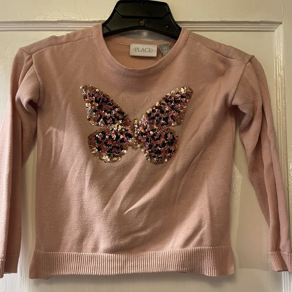 Girl’s pink sweater with sequin butterfly